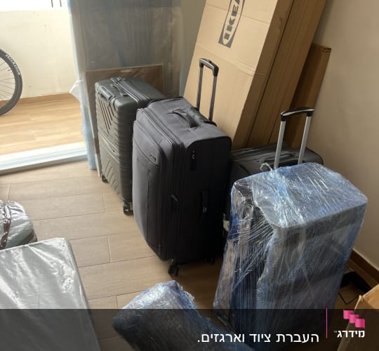 מזוודות וארגזים עטופים בניילון בחדר